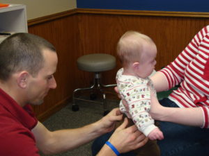 baby receiving chiropractic adjustment